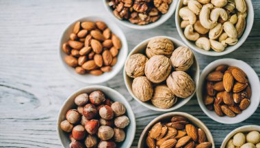 set of nuts, walnuts, almonds and almond on a wooden background top view close up