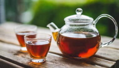 Köy arka planında çaydanlık olan çay. çay kavramı.