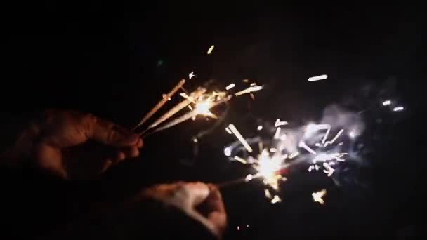 Closeup άποψη των χεριών κρατώντας φώτα bengal, Χριστούγεννα και το νέο έτος κόμμα sparkler, το νέο έτος 2020 — Αρχείο Βίντεο