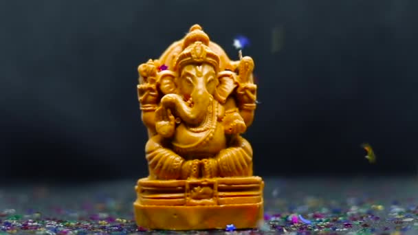 Ganesh Chaturthi Concept Statue Hindu God Ganapati Black Background Confetti — Stock Video