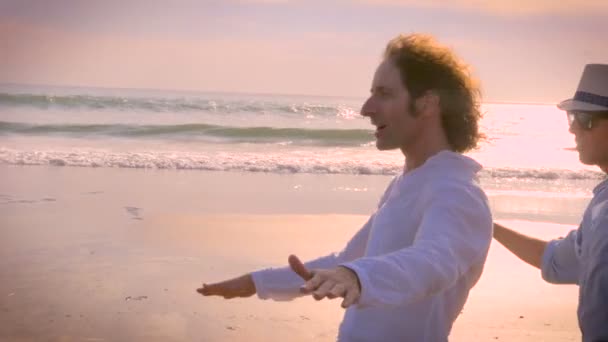 Slow mo hand held shot of two male friends surfing an imaginary wave — Stock Video