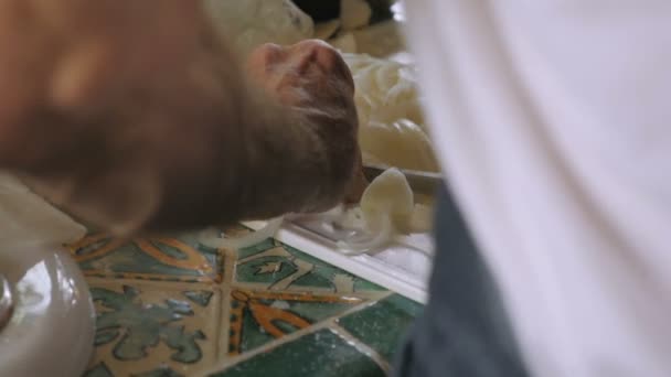 A man chopping onions shot from behind in slow motion — Stock Video