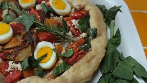Huisgemaakte plantaardige torte met eieren, kaas, tomaten, uien en kruiden — Stockvideo