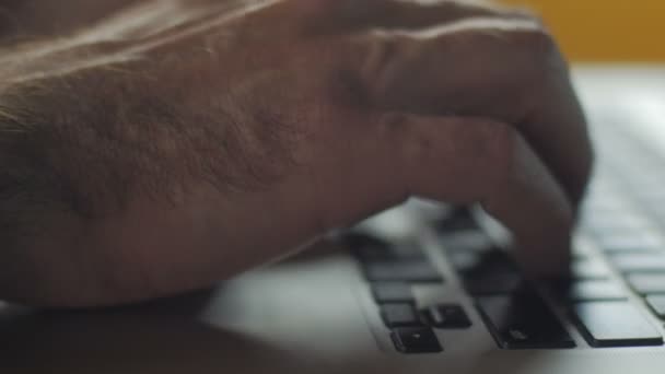 Close up of man typing on a laptop computer keyboard — Stock Video