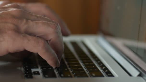 Доллі крупним планом чоловік друкує на клавіатурі комп'ютера ноутбука — стокове відео