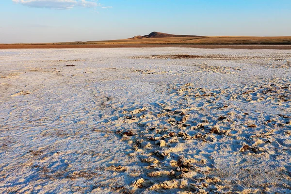 Crosta di sale sulla superficie del deserto e della montagna solitaria — Foto Stock