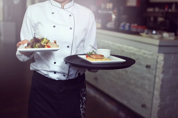 Waiters carrying plates with meat dish at a wedding — Stock Photo, Image