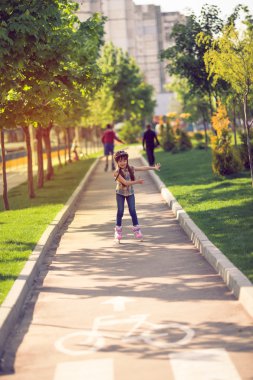 Çekici genç kız parkta paten