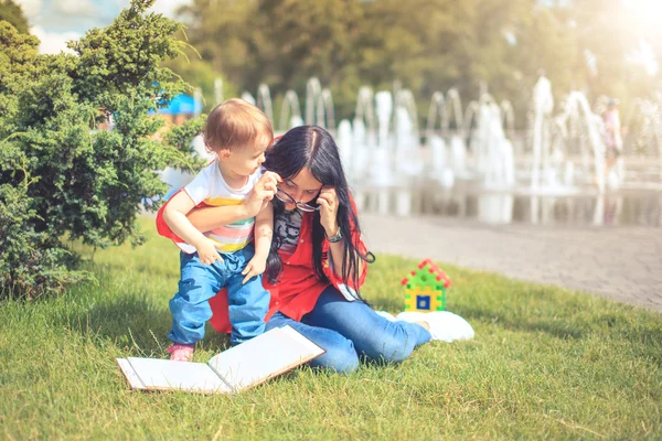 Bela mãe e criança menina ao ar livre mãe feliz mostrando-lhe — Fotografia de Stock