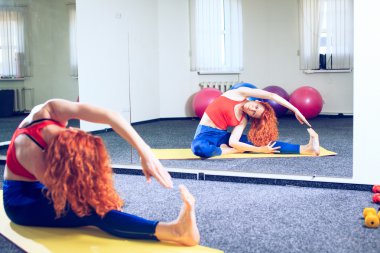 genç kadın eğitmen Spor Kulübü egzersizleri Pilates yapıyor