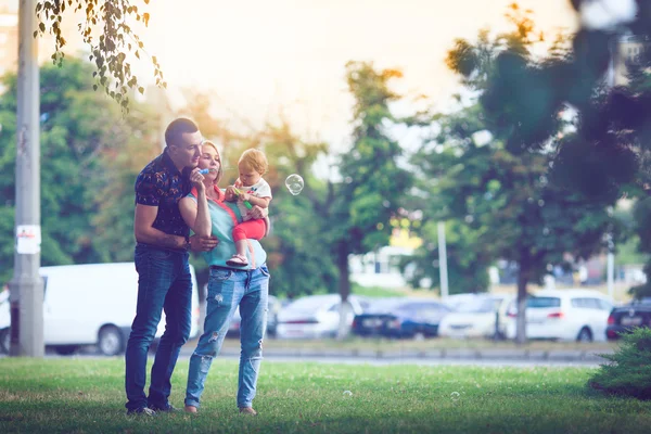 Счастливая семья проводит выходные в летнем парке — стоковое фото