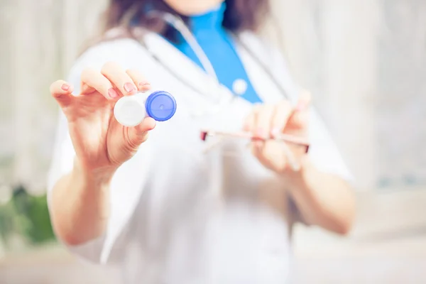 Handen van de arts geven paar contact lens geval aan patiënt offe — Stockfoto