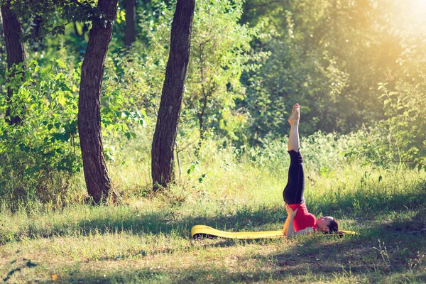 Jeune fille faisant du yoga dans le parc — Photo