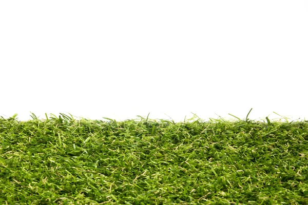 Artificial fundo grama verde no fundo branco — Fotografia de Stock