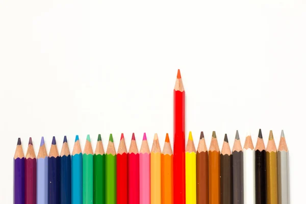 Red color pencil shift from the row of another on white background — Stock Photo, Image