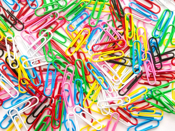 Pile of colorful paper clip on white background