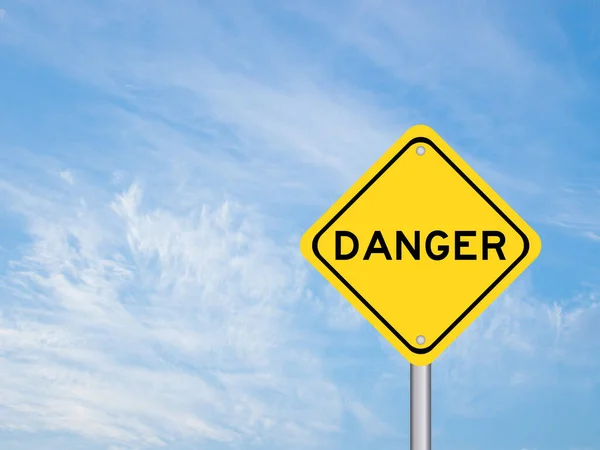 Yellow transportation sign with word danger on blue sky background