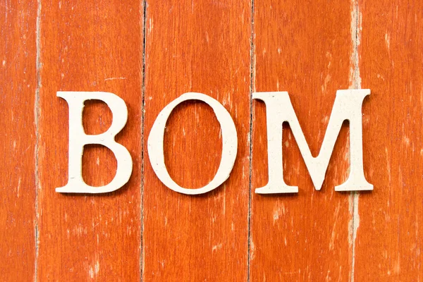 単語のアルファベット文字Bom 材料の法案の略語 古い赤い色の木の板の背景に — ストック写真