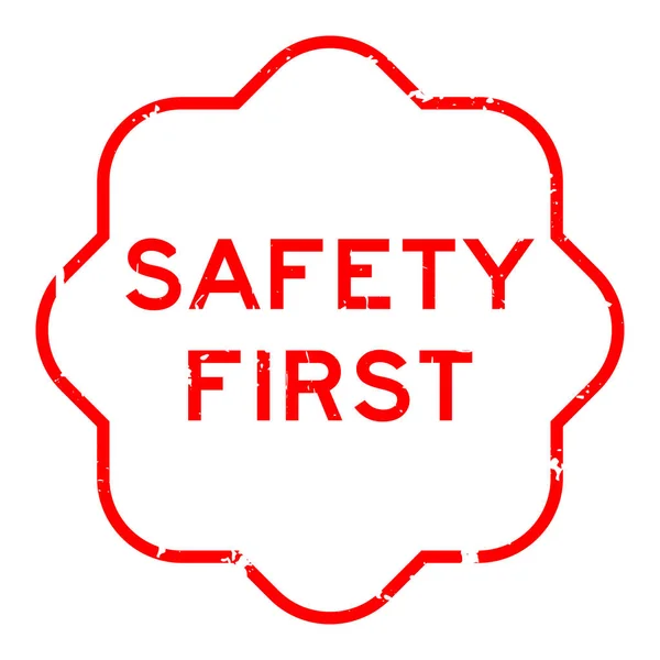 白色背景上的红色安全第一字橡皮图章 — 图库矢量图片