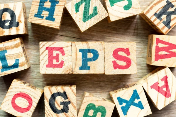 Alphabet letter block in word EPS (Abbreviation of Earnings per share) with another on wood background