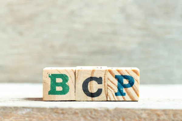 Alphabet letter block in word BCP (abbreviation business continuity plan) on wood background