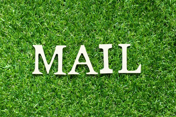 Alphabet letter in word mail on green grass background