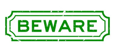 Grunge yeşil dikkat kelime lastik iş mühür beyaz arka planda