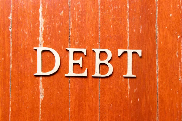 Alphabet Buchstabe Wort Schulden Auf Alten Roten Farbe Holzteller Hintergrund — Stockfoto