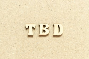 Alphabet letter in word TBD (Abbreviation of to be defined, discussed, determined, decided, deleted or declared) on wood background clipart