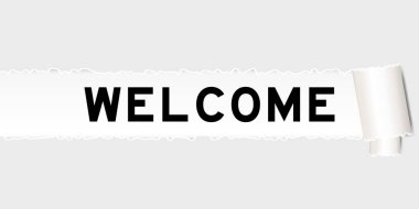 Parçalanmış gri kağıt altında kelime hoş geldin yazılı.