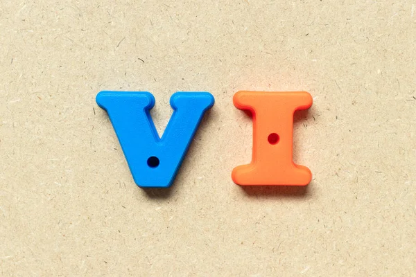 Plastic alphabet letter in word VI (abbreviation for value investor) on wood background