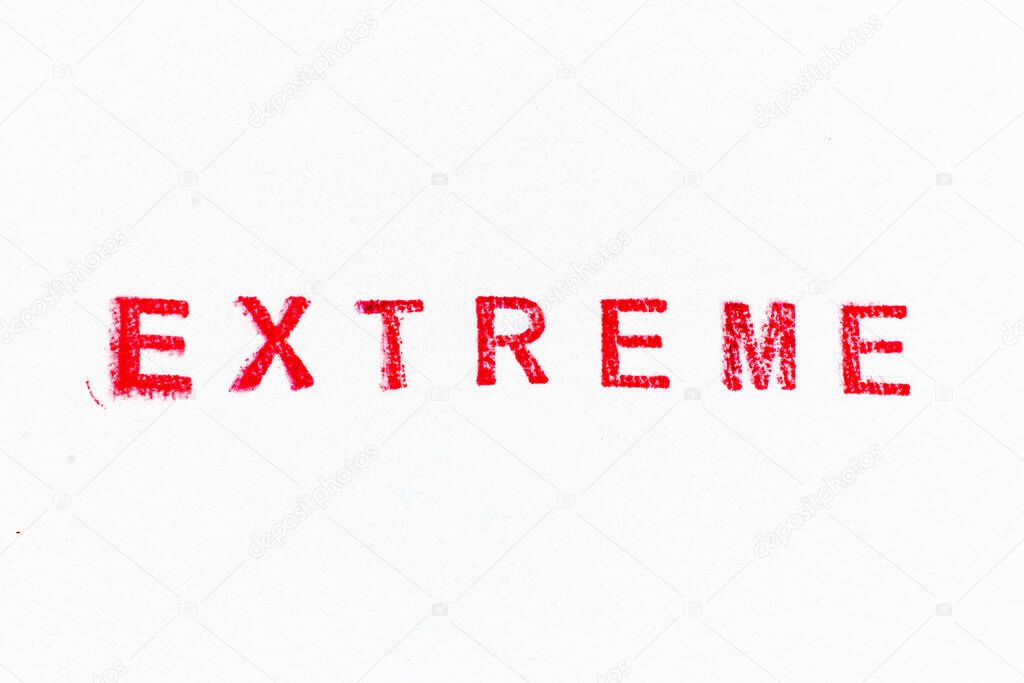 Red color ink rubber stamp in word extreme on white paper background