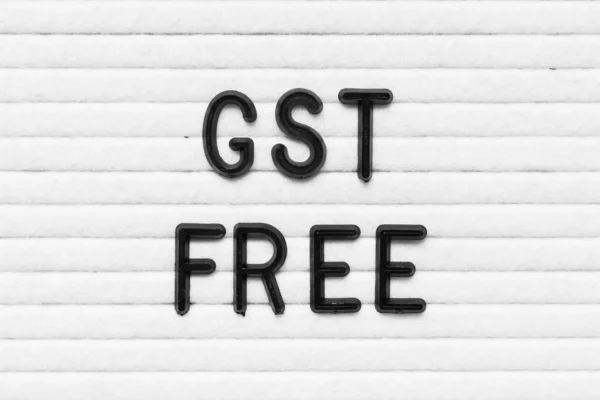 Black alphabet letter in word GST (Abbreviation of Goods and Services Tax) free on white felt board background