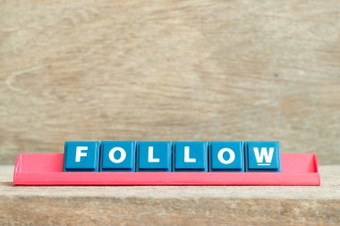 Kelime ile alfabe harfini ahşap arka planda kırmızı rafta takip et