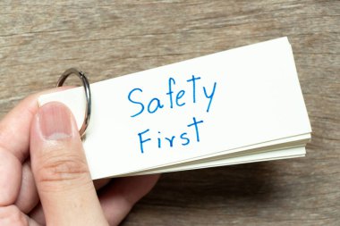 Adam önce ahşap arka planda el yazısıyla güvenlik kartını tut.