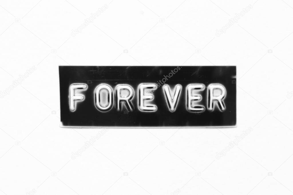 Black color banner that have embossed letter with word forever on white paper background