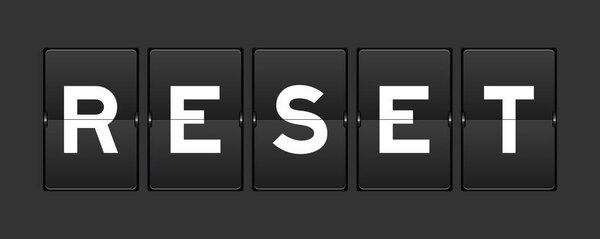 Black color analog flip board with word reset on gray background