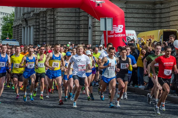 LVIV, UKRAINE - APRIL, 2016: Participants of marathon athletes run start take on Prospect of Freedom in Lviv, Ukraine Stock Photo