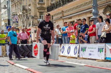 Lviv, Ukrayna - Haziran 2016: Diktatör bir büyük şişirilmiş metal gövdeli ağır bavul taşır