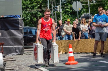 Lviv, Ukrayna - Haziran 2016: Diktatör bir büyük şişirilmiş metal gövdeli ağır bavul taşır