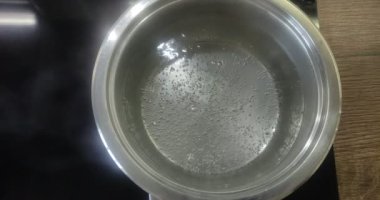 Water boils in a saucepan on an induction hob