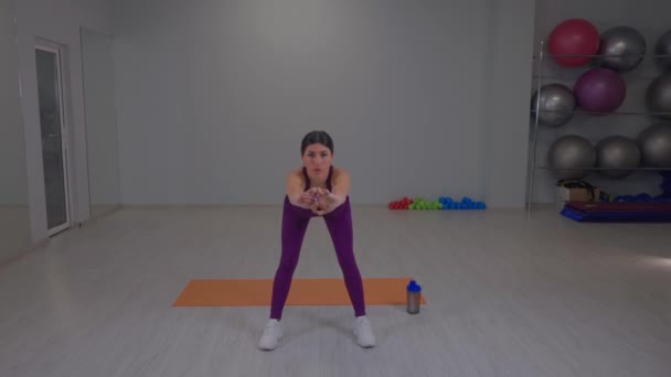 Athletic girl doing forward bends — Wideo stockowe