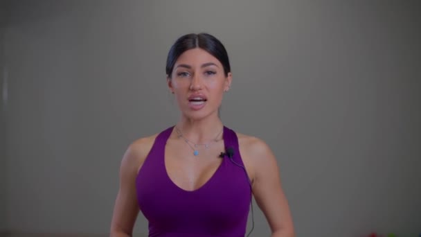 Biquíni menina fitness diz algo para a câmera — Vídeo de Stock