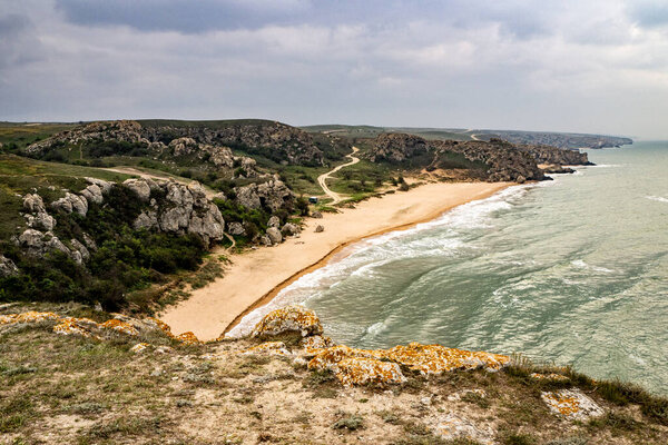 Mountains of steel and stones on the seashore. Wild beach. holidays, privacy, 