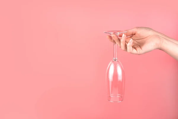 Abstrakcyjne tło z kobiecą ręką trzymającą kieliszek szampana do góry nogami. — Zdjęcie stockowe