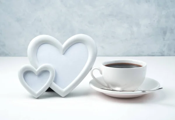 Frame of two hearts and a Cup of coffee on a light background. — Stock Photo, Image