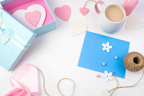 Hearts, blue envelope and gift box on a light background. Royalty Free Stock Images
