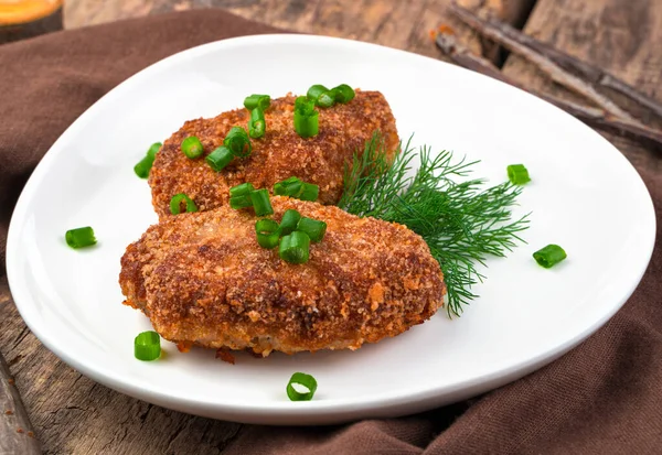Two juicy meat cutlets close-up on a natural wooden background. — Stock Photo, Image