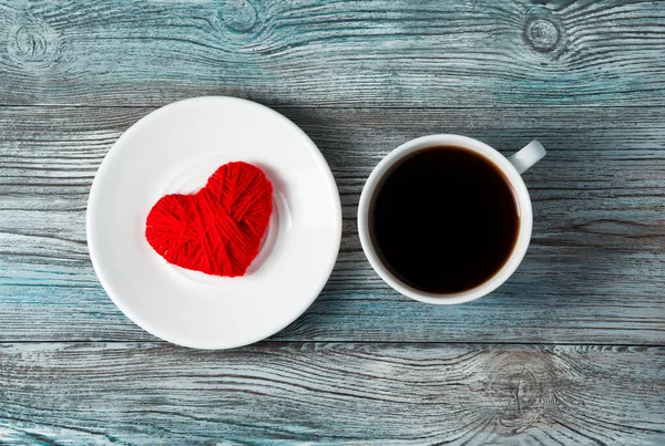 Romantic background with red heart, saucer and coffee Cup on grey-blue wooden background. — Stock Photo, Image