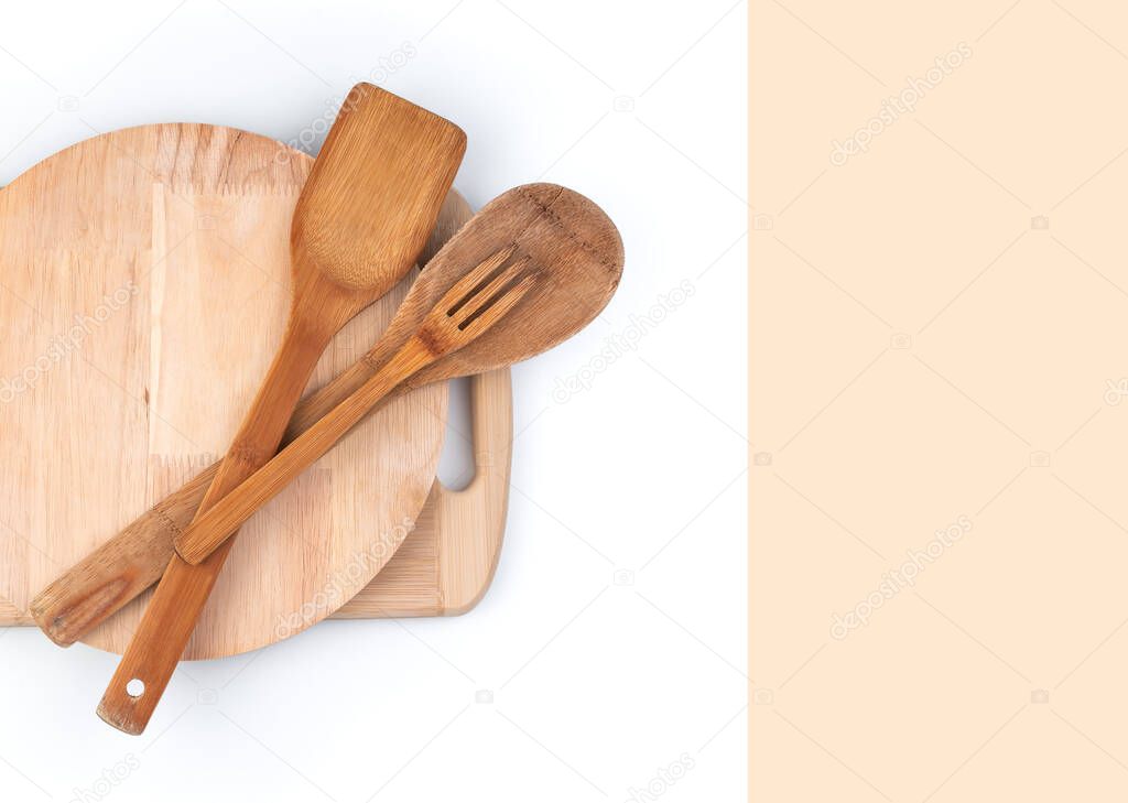 Cutting boards and wooden spatulas on a white background with space to copy.
